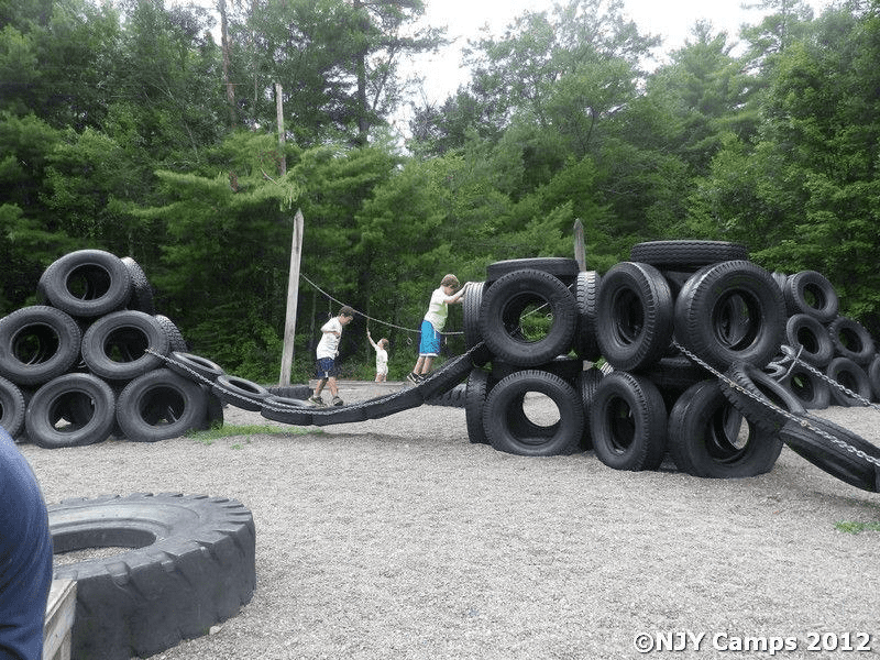 Kids playing on a playground made of tires